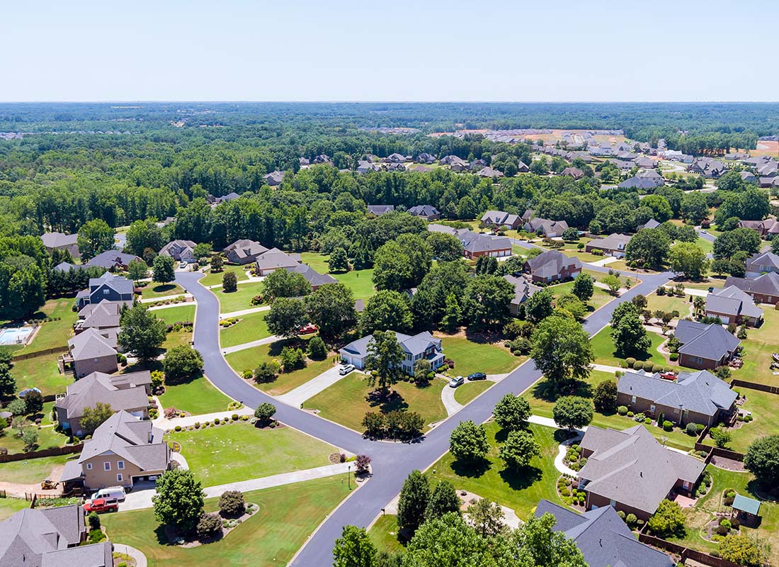 St Matthews, SC - Aerial View of Homes Surrounded by Green Grass and Trees on a Sunny Day in St Matthews South Carolina